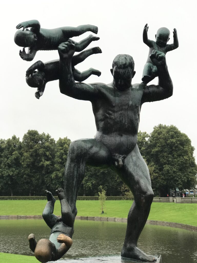Large bronze sculpture of a man lifting children in Vigeland Park, Oslo