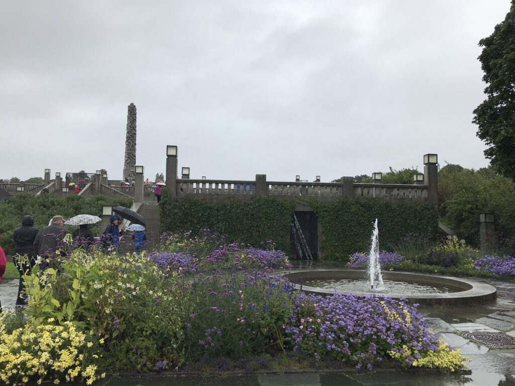 Flower beds and central fountain in Vigeland Park on an overcast day