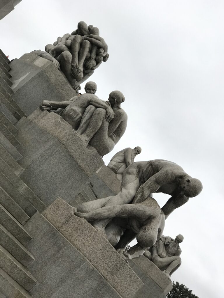 Close-up of stone sculptures of human figures climbing in Vigeland Park, Oslo