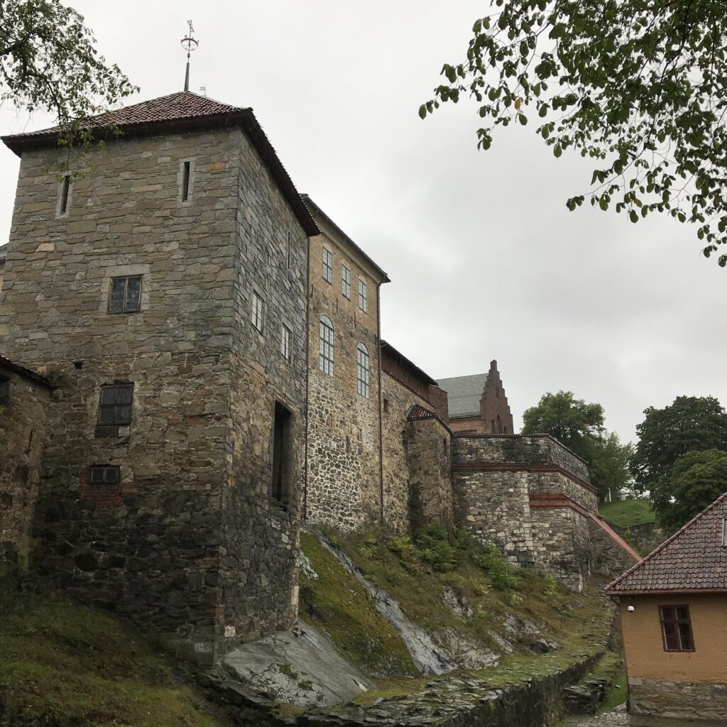 Stone tower and sloped hillside inside Akershus Fortress in Oslo, Norway
