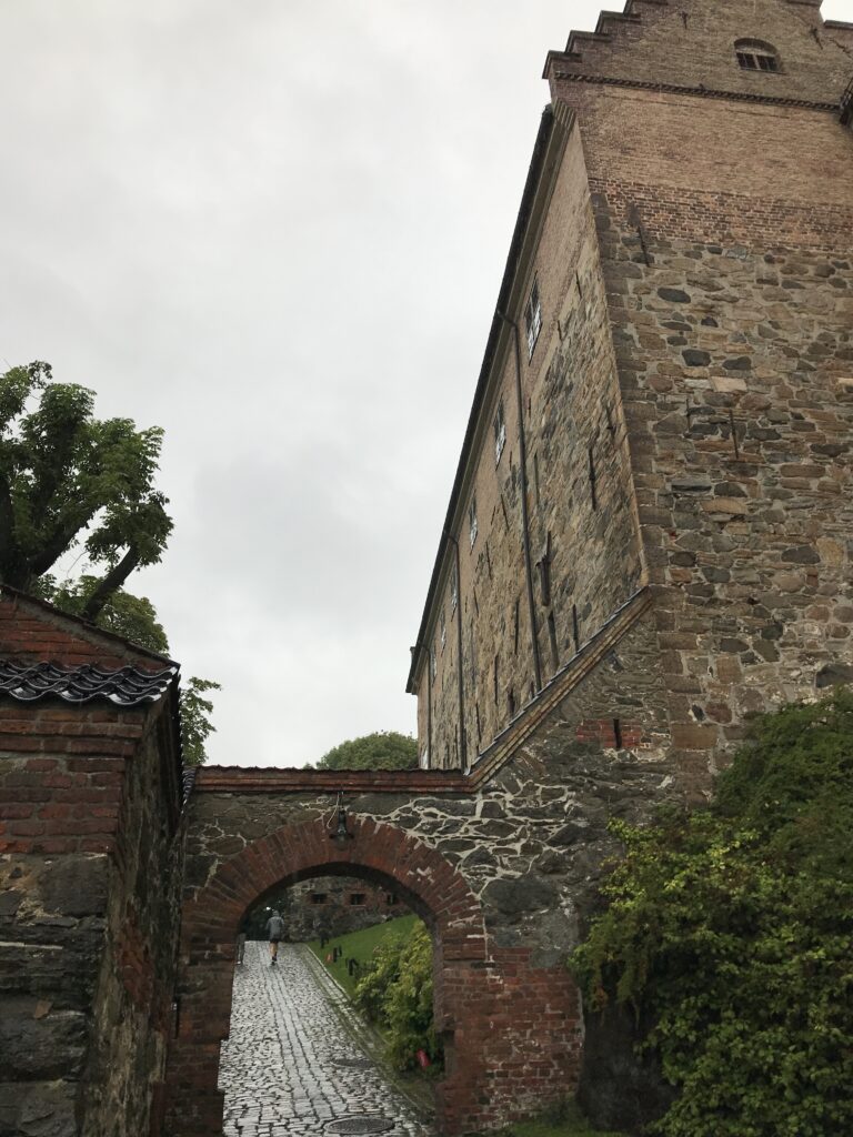 Tall stone wall and archway inside Akershus Fortress in Oslo