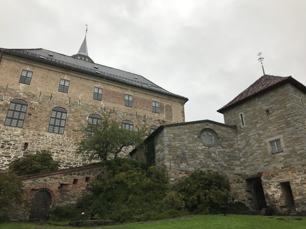 Historic buildings and stone structures inside Akershus Fortress courtyard