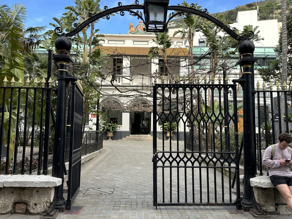 Decorative gated entrance to a historic building courtyard in Gibraltar.
