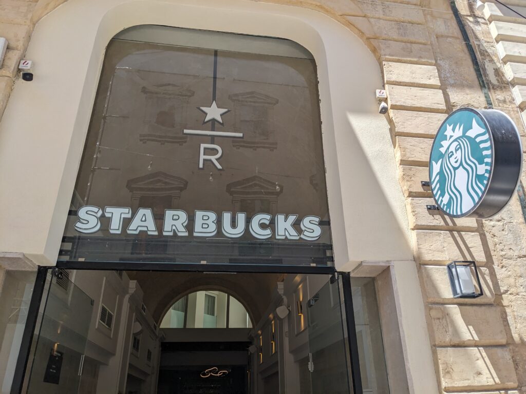 Entrance to the Starbucks Reserve in Malta. This shows the top half of the entry door with the logo in glass above it.