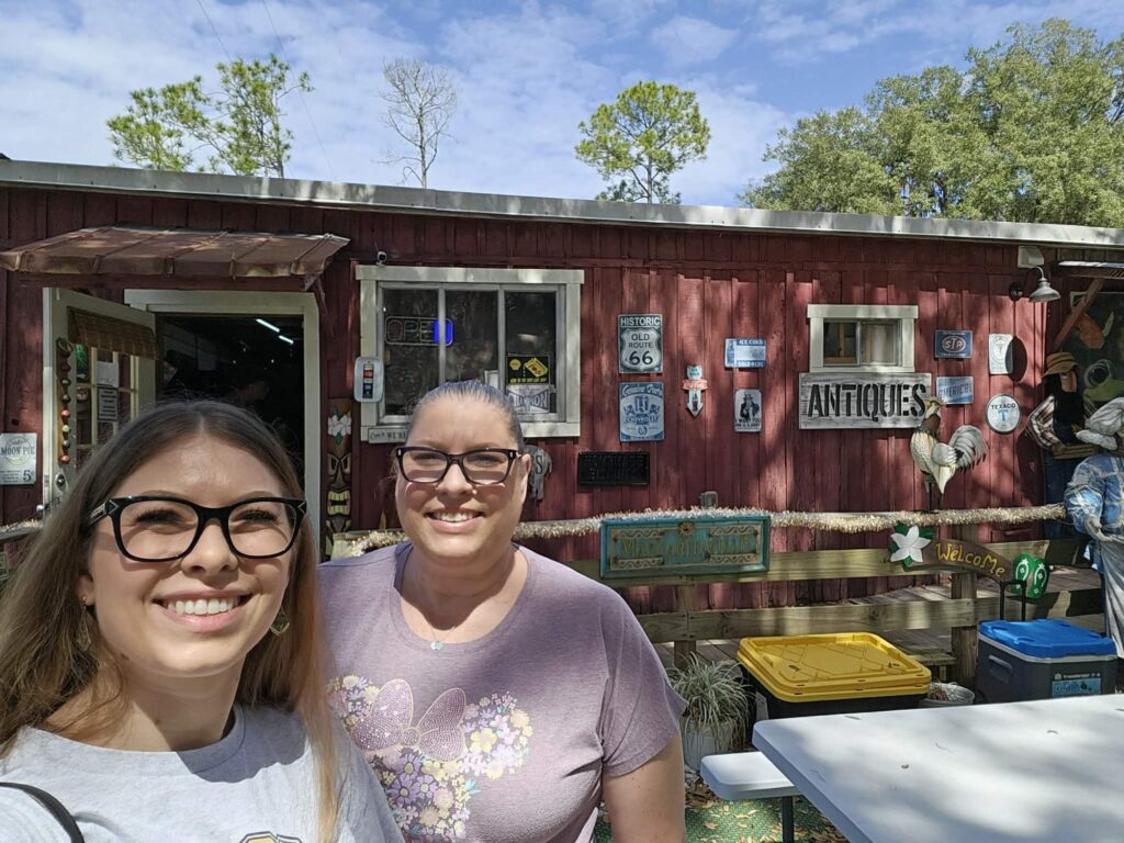 Lind and Lori standing in front of one of the buildings in Shanty Town Village.