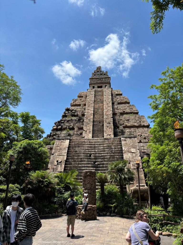 Ancient temple pyramid at Tokyo DisneySea’s Lost River Delta surrounded by lush greenery under blue skies