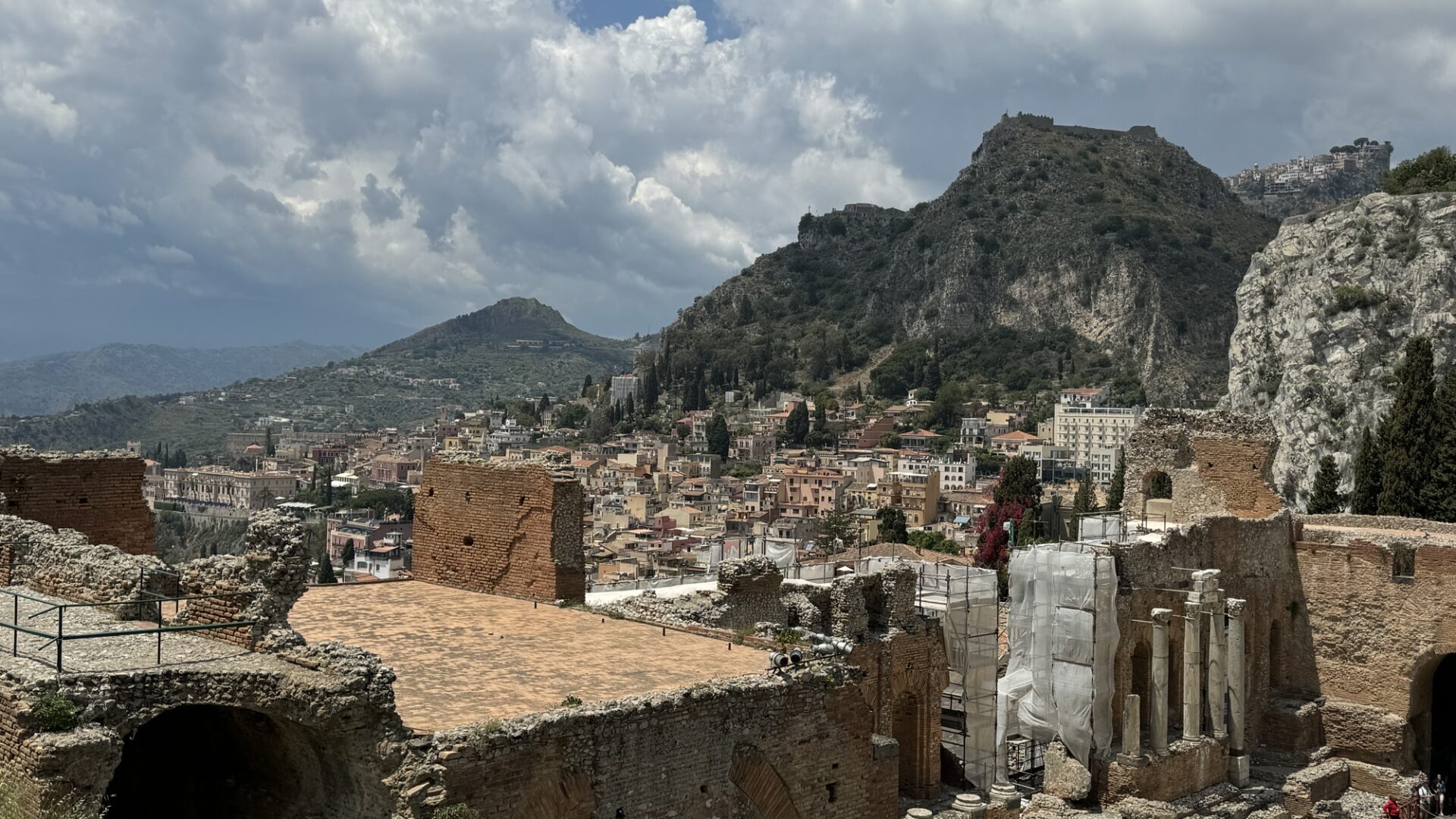 Panoramic view of Taormina’s rooftops and surrounding mountains seen from the ruins of the ancient theatre.
