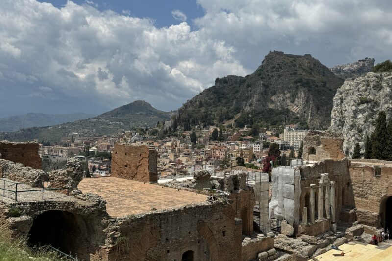 Panoramic view of Taormina’s rooftops and surrounding mountains seen from the ruins of the ancient theatre.