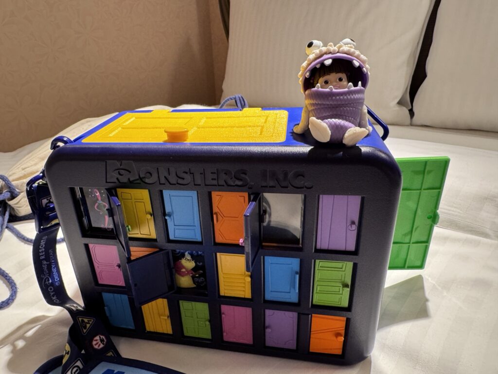 Monsters Inc themed souvenir popcorn container with colorful doors and Boo figure on top at Tokyo DisneySea