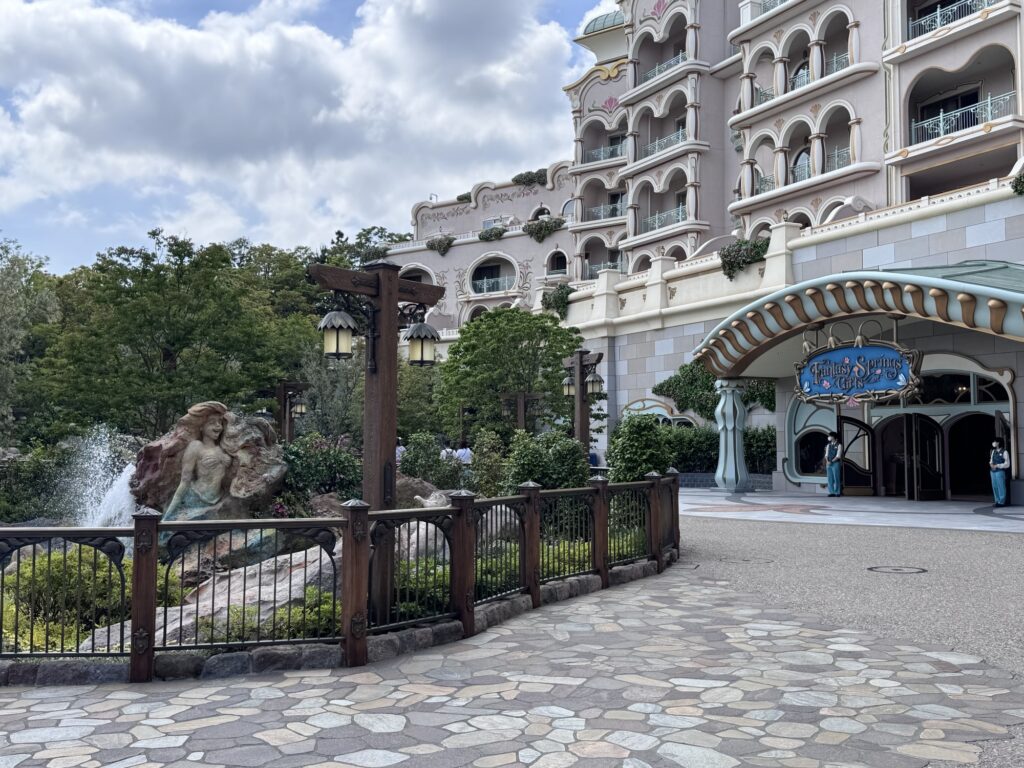 Tokyo DisneySea Fantasy Springs hotel entrance with ornate Mediterranean-style architecture and landscaped walkway near the waterfront