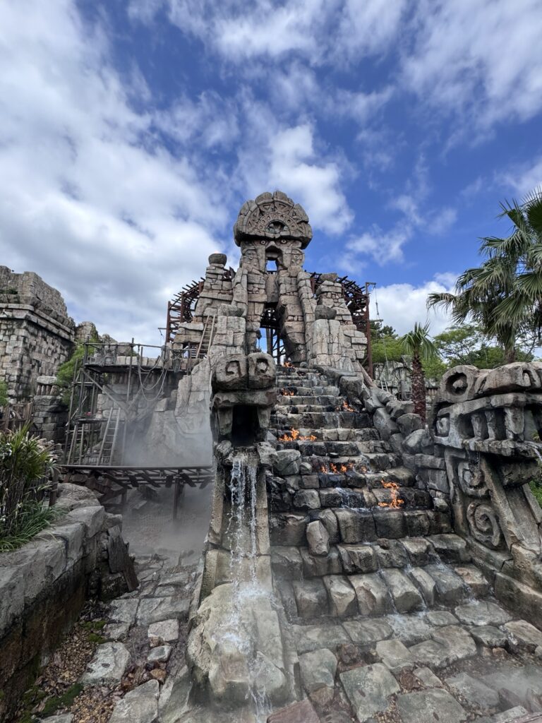 Temple of the Crystal Skull entrance at Tokyo DisneySea with stone staircase, fire effects, and carved statues