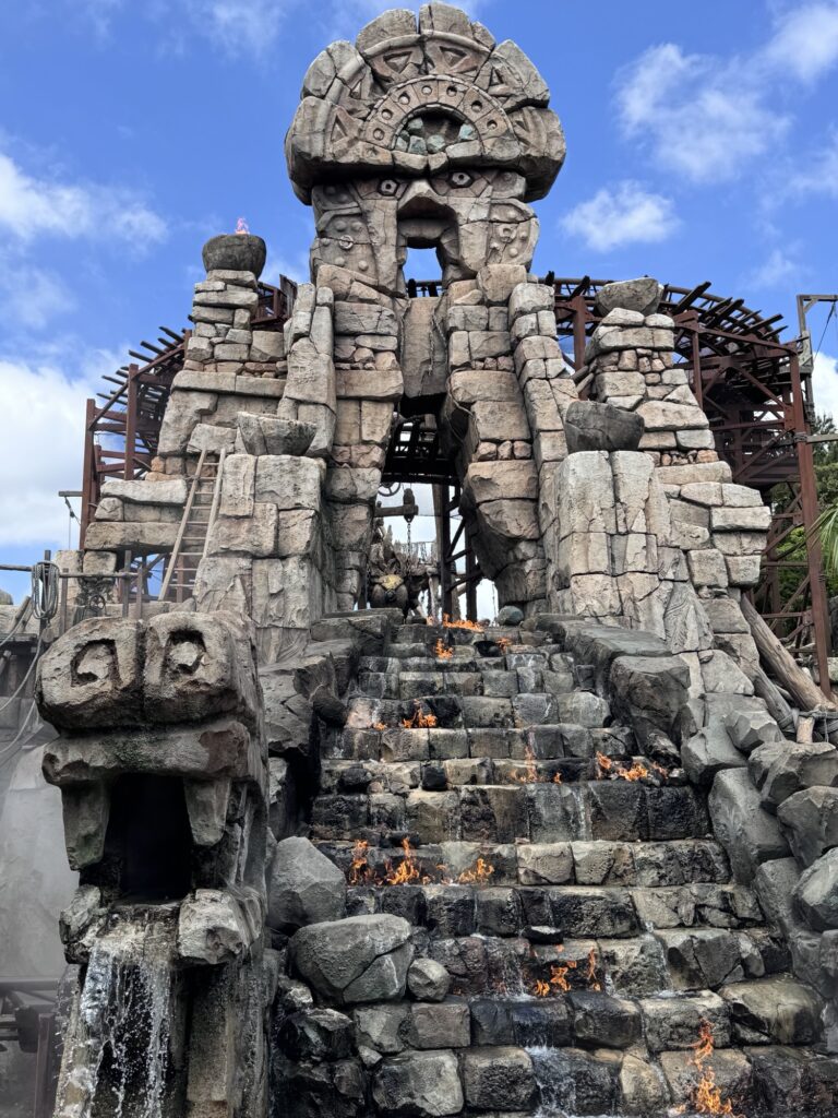 Closer view of Temple of the Crystal Skull at Tokyo DisneySea showing stone carvings, fire details, and weathered textures