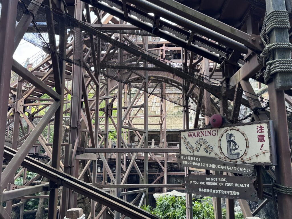 Intricate steel framework of Indiana Jones Adventure ride at Tokyo DisneySea with layered beams and industrial theming