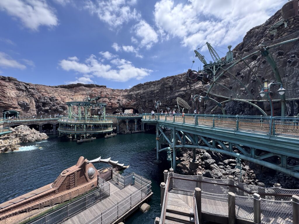 Walkways and platforms in Tokyo DisneySea’s Mysterious Island with industrial-style structures built into rocky cliffs