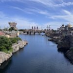 A waterway at Tokyo DisneySea with the tower of terror and the titanic in the background.