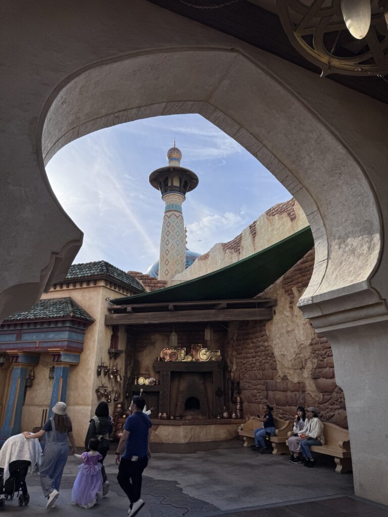 View through archway in Tokyo DisneySea’s Arabian Coast framing a tall decorative tower