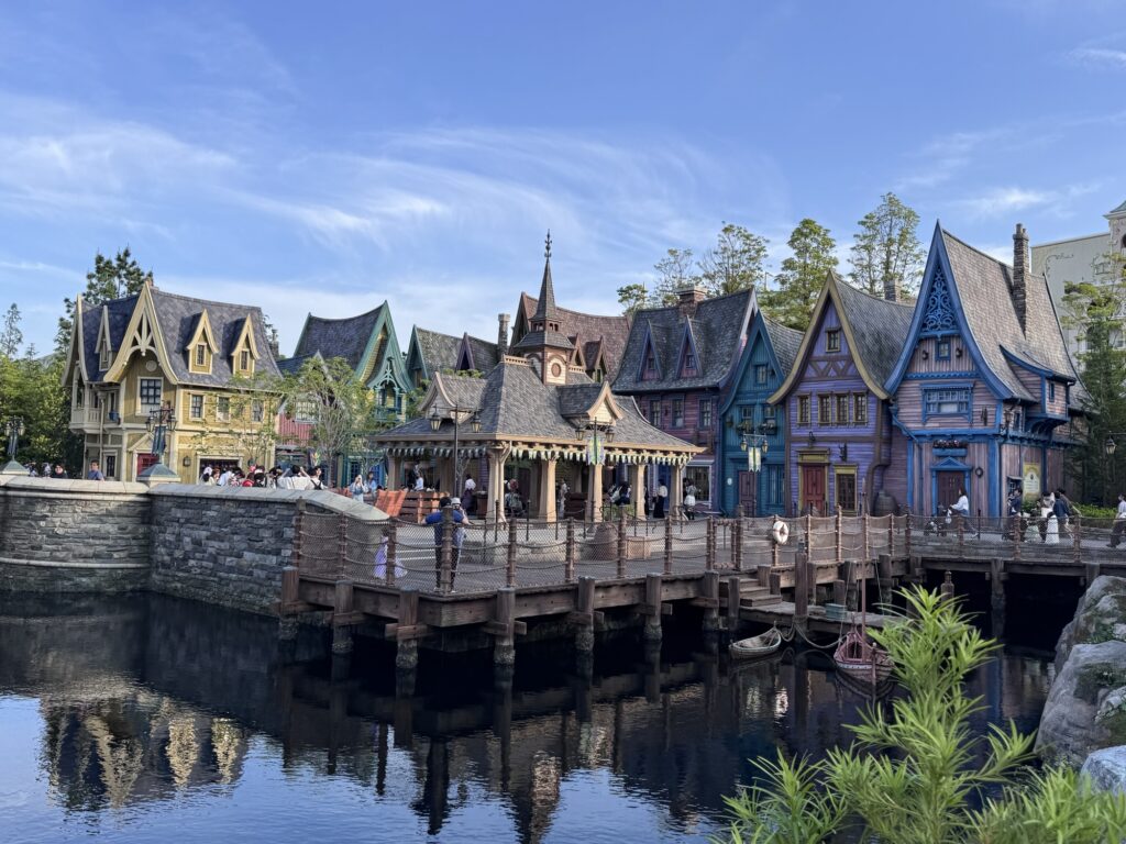 Scenic waterfront village at Tokyo DisneySea with colorful buildings and calm reflective water
