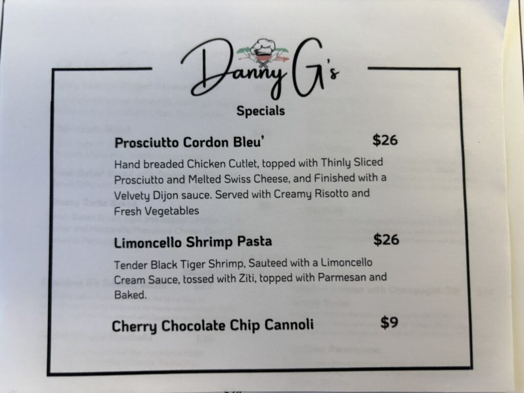 Printed specials menu from Danny G’s restaurant listing prosciutto cordon bleu for $26, limoncello shrimp pasta for $26, and cherry chocolate chip cannoli for $9, with descriptions of each dish.