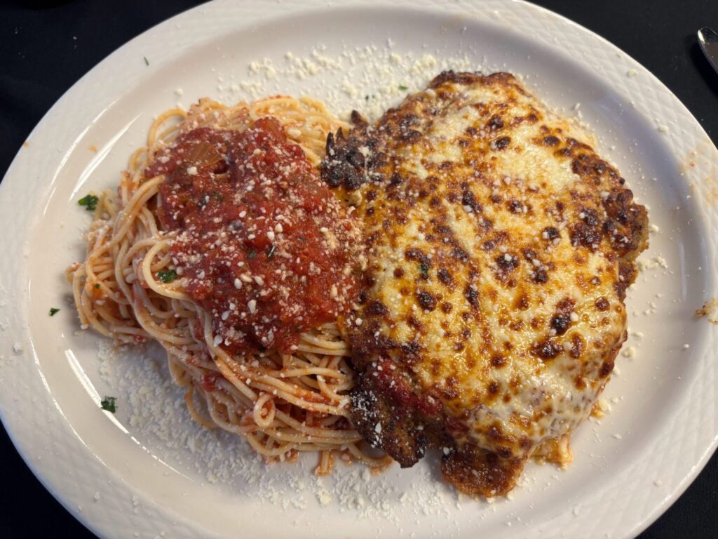 Chicken Parmigiana covered with house-made marinara and melted mozzarella and aged parmesan. Presented with spaghetti marinara.