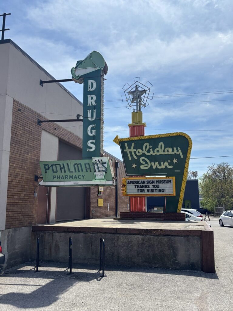 Entrance of the American Sign Museum. The holiday inn neon sign and also Pohlman's pharmacy sign