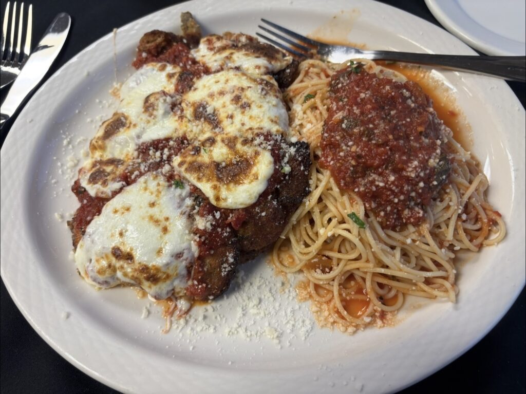 Eggplant Parmigiana covered with house-made marinara and melted mozzarella and aged parmesan. Presented with spaghetti marinara.