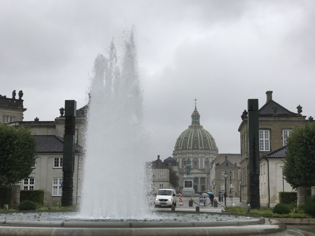 Frederik’s Church seen through a fountain on a rainy day in Copenhagen Denmark