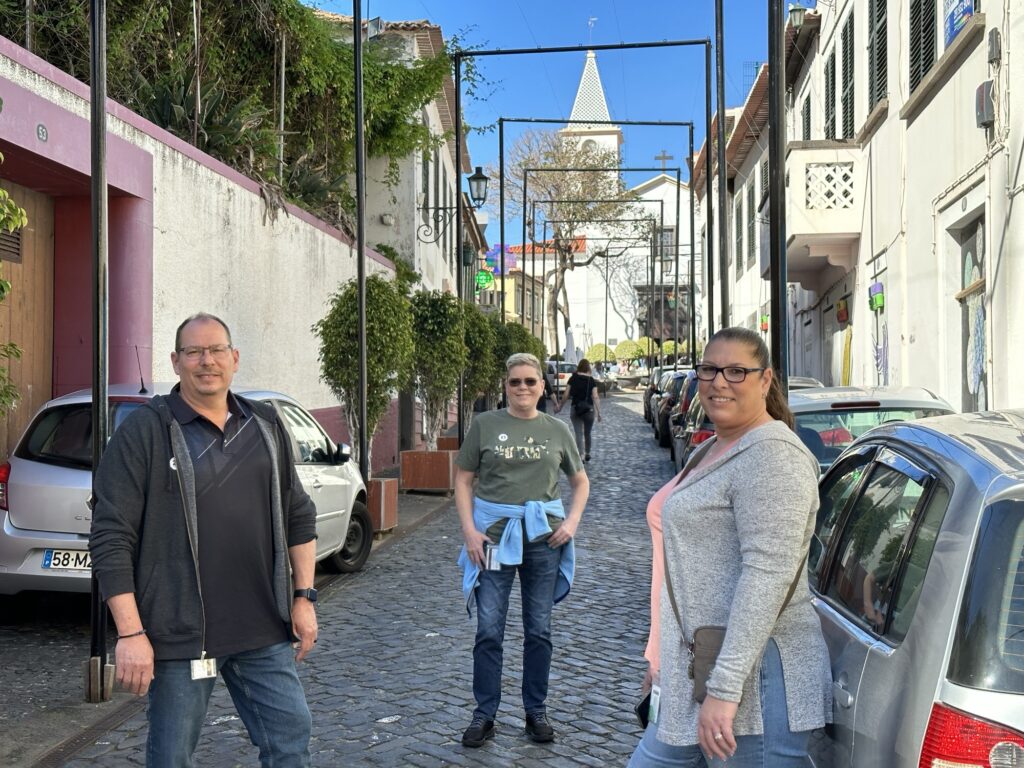 Travelers walking along a narrow street in Funchal Madeira during a cruise port day