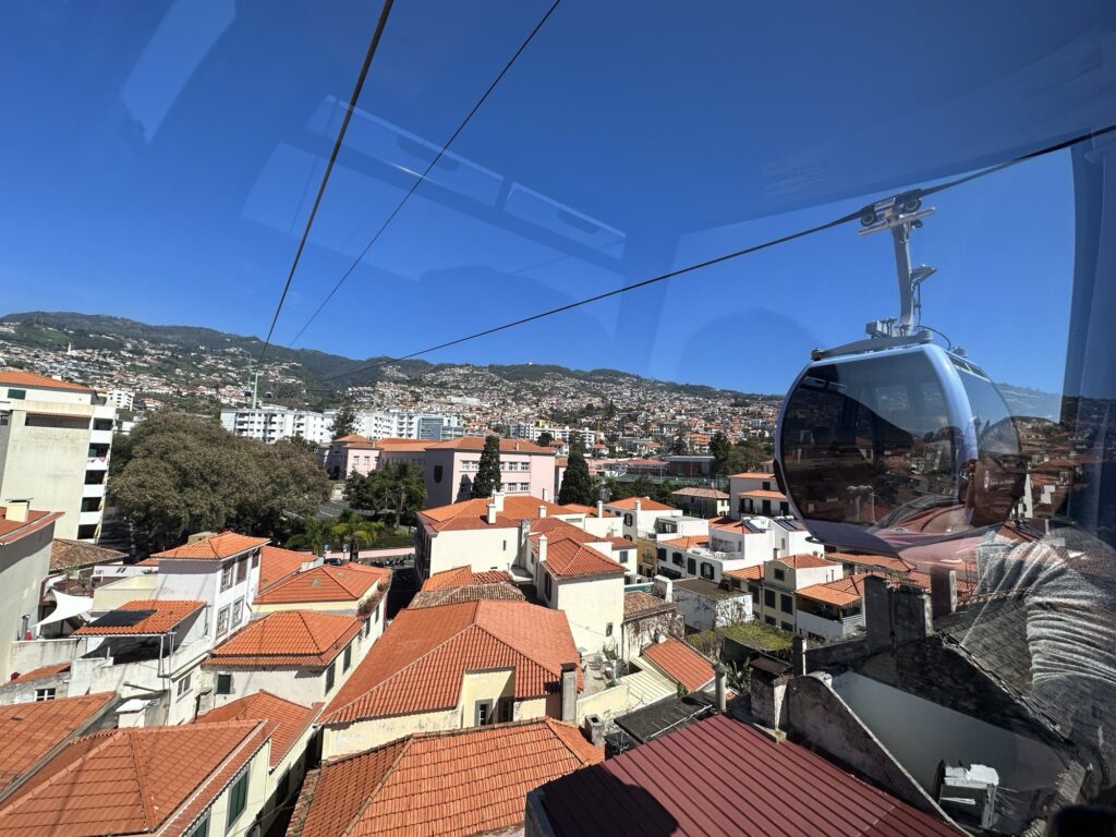 Cable car gondola over Funchal Madeira with panoramic views of the city and mountains