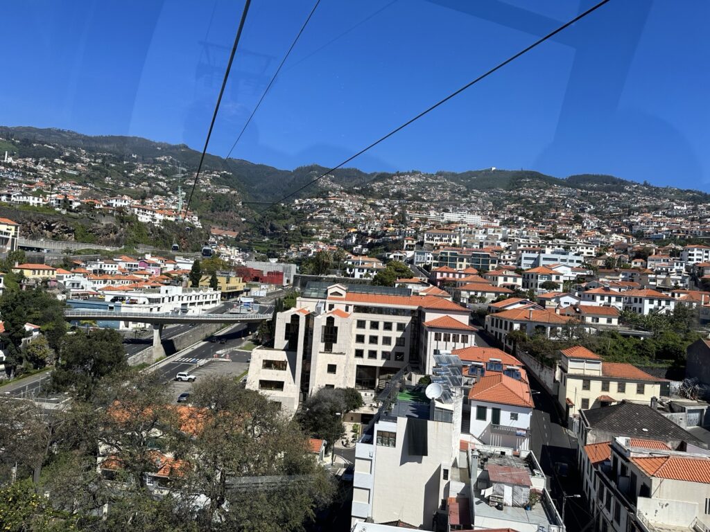 Aerial view of Funchal Madeira from the cable car with red rooftops and hillside homes