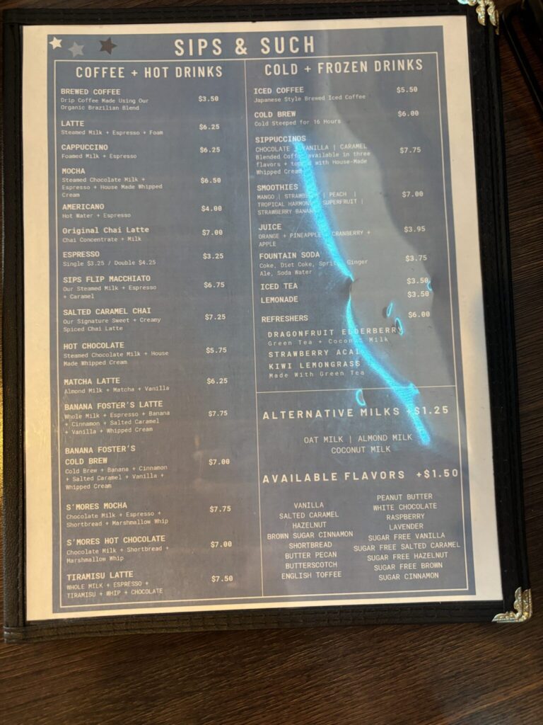 Menu page for "Sips & Such" coffee shop displaying hot drinks, cold beverages, and pricing options