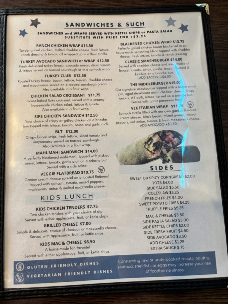 Menu page displaying sandwiches, wraps, kids lunch options, and sides at a casual restaurant